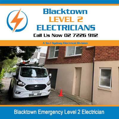Emergency electricians service van parked at residential brick building with safety cone in Blacktown