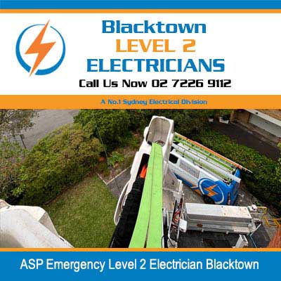 Aerial view of utility truck with equipment positioned in residential driveway for emergency electrical work in Blacktown
