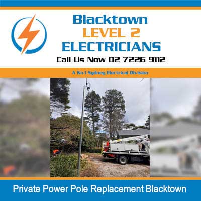 Utility truck with boom lift for power pole replacement in residential area in Blacktown